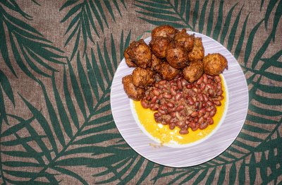 Vue de dessus – Red beans à palm oil et camerounais corn fritters sur un tropical background