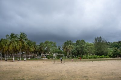 Children jouant soccer sous un orageux ciel à San Pedro, Côte d'Ivoire