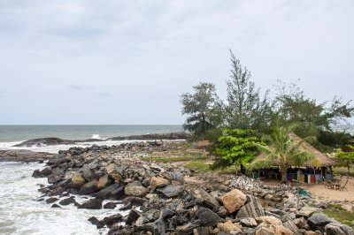 Africain rocheux coastline avec straw paillote et palmiers – Authentic coastal tourism