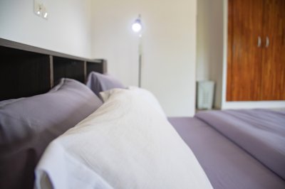 Detail de un moderne bed avec white cushions et gray sheets
