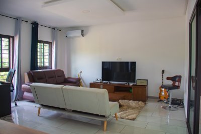 Lumineux moderne salon avec flat-screen TV, Xbox One S, et musical decor